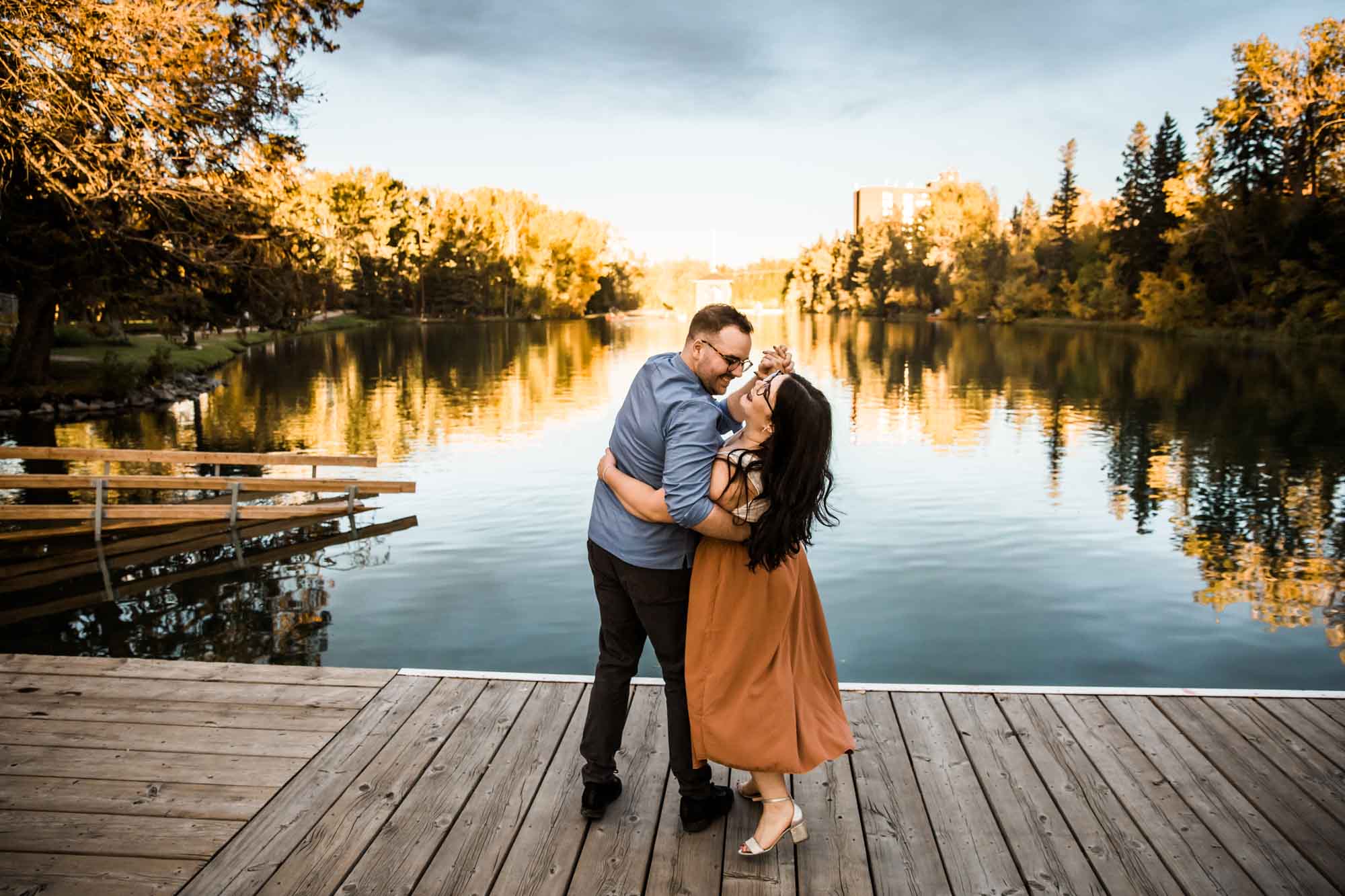 Calgary wedding photographer, engagement photos at Bowness Park, couple in front of fall trees