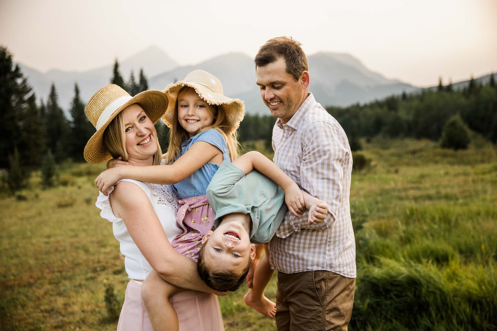 Calgary, Banff and Kananaskis Country lifestyle family photographer, family in front of water and mountains during their photoshoot in Kananaskis Country
